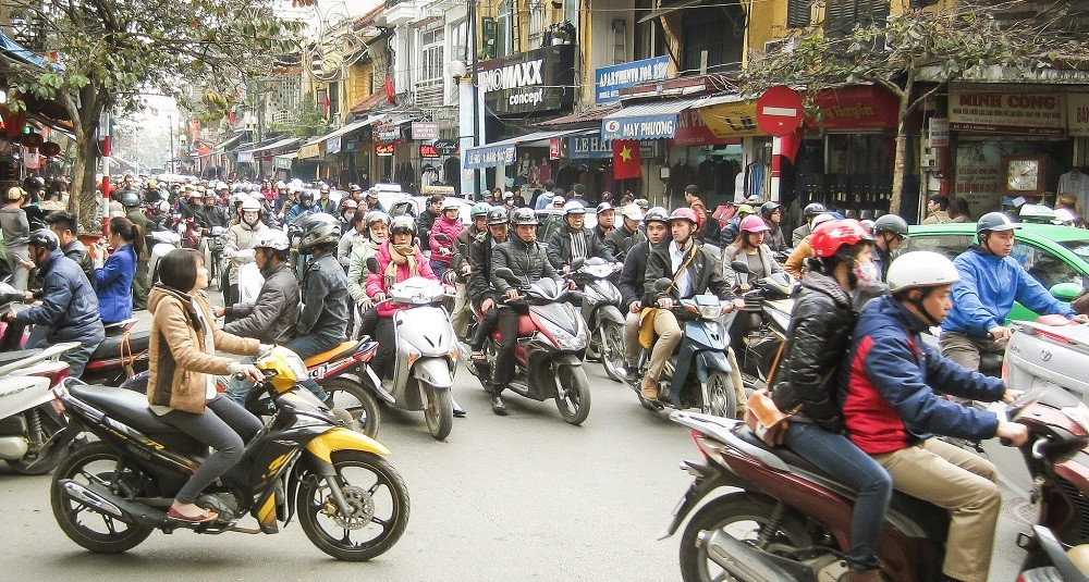 Delivery driver facing Asia digital economy challenges due to high fuel costs in Vietnam