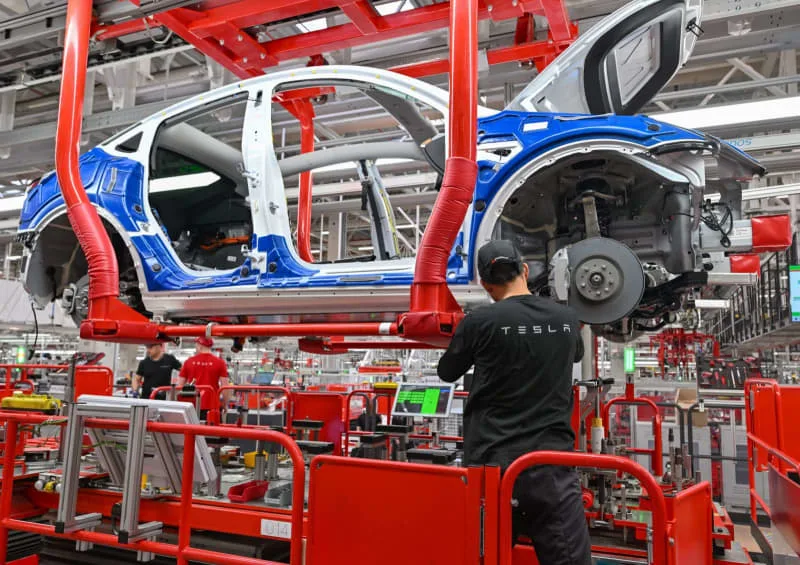 German Union Tesla Negotiations Erupt as Workers Challenge Conditions at Tesla Gigafactory Berlin 2026 3 Workers inside Tesla Berlin factory during German union Tesla negotiations discussion
