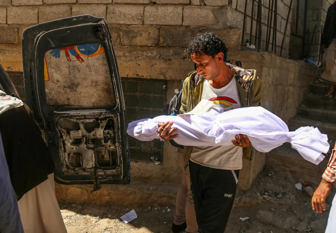 A person carrying a dead body of child
