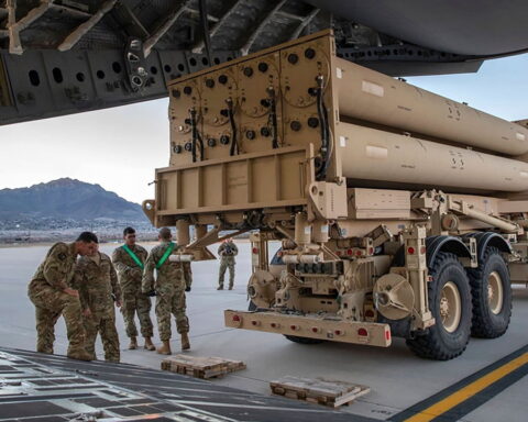 Israel air defense system intercepting missiles over Israeli city at night