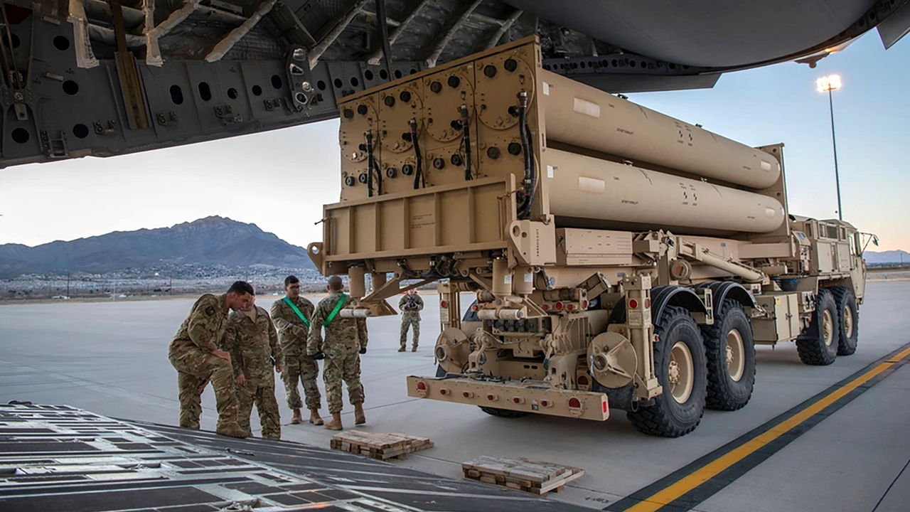 Israel air defense system intercepting missiles over Israeli city at night