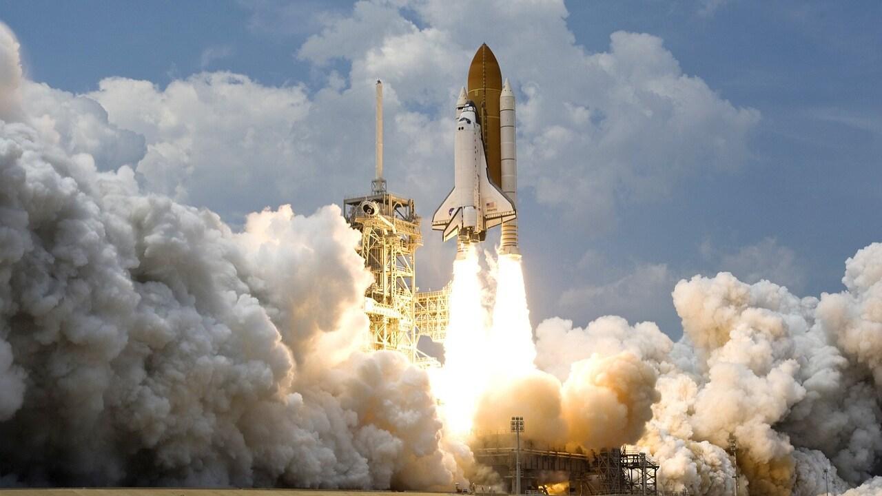 Engineers monitoring AI space technology systems inside aerospace command center