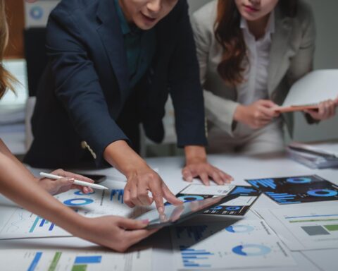 A professional analyzing a data dashboard that illustrates company-wide AI productivity growth.