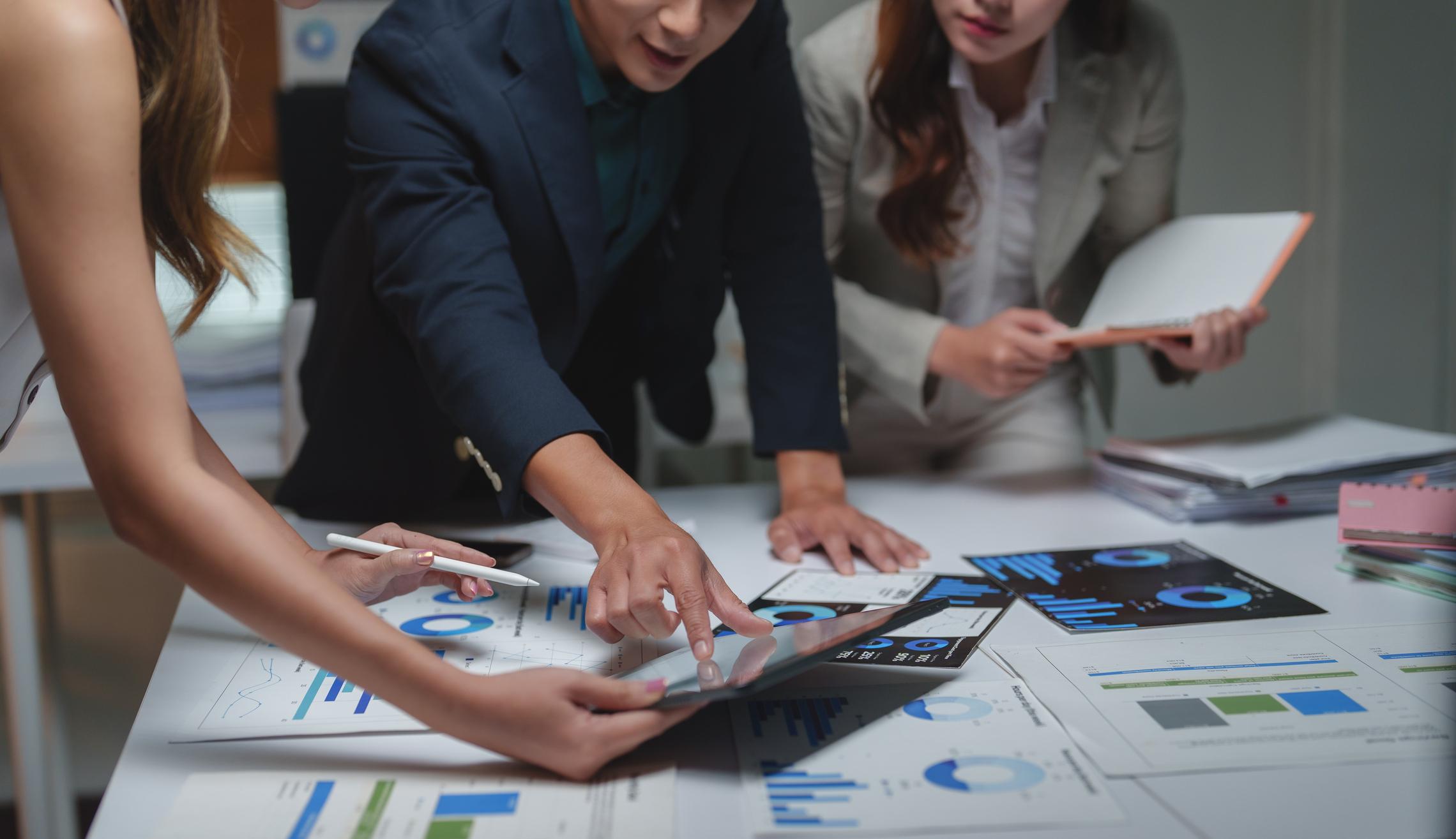 A professional analyzing a data dashboard that illustrates company-wide AI productivity growth.