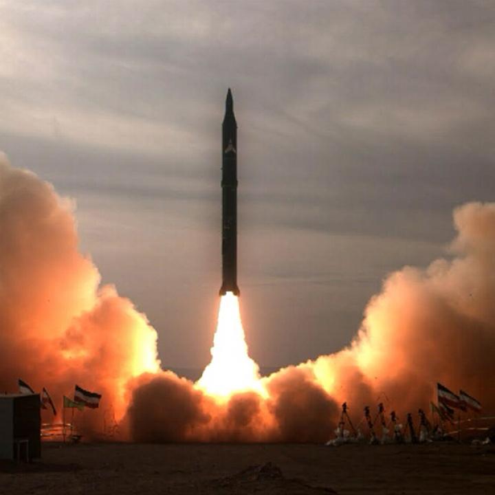 Iran missile launch showing ballistic rocket rising from desert launch site