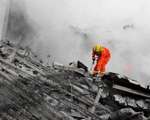 Tehran rescue operation emergency crews use heavy machinery to clear debris