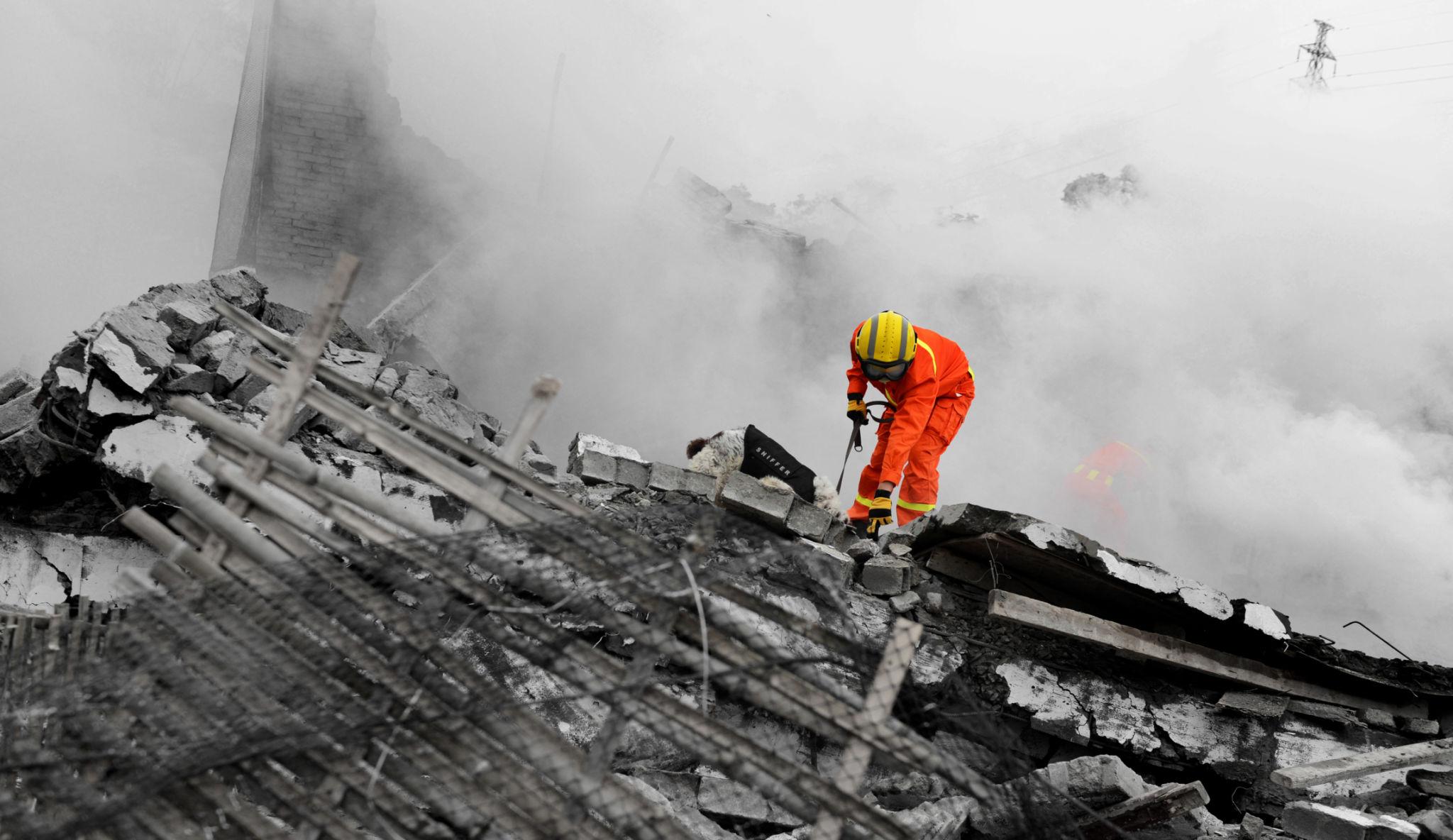 Tehran rescue operation emergency crews use heavy machinery to clear debris