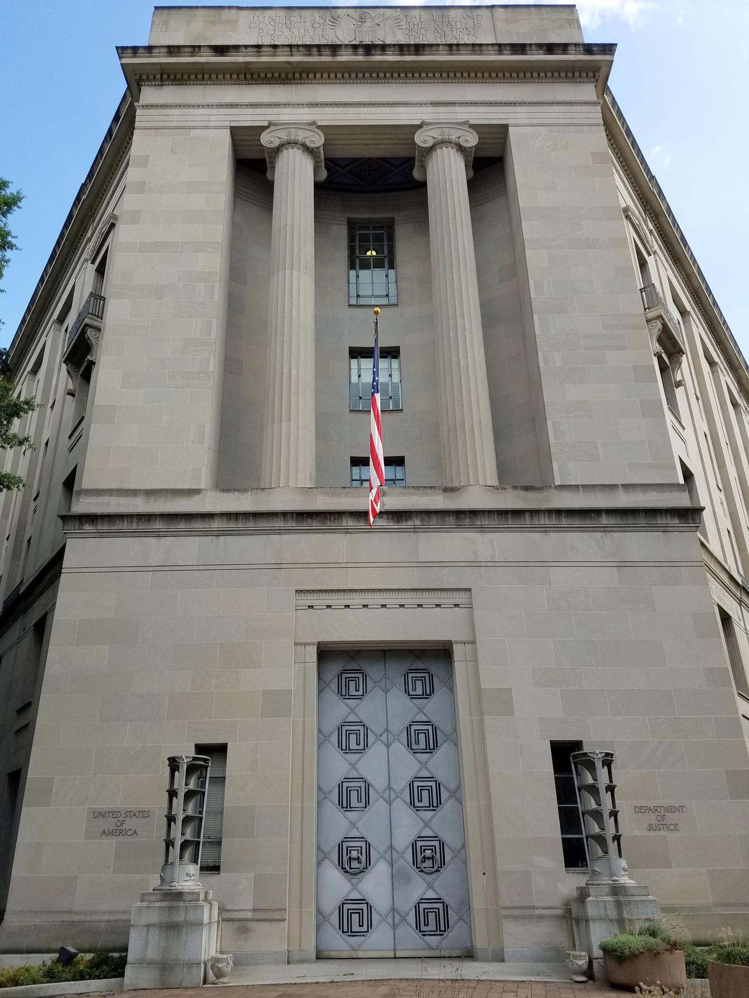 Federal Building Security Tightened After DOJ Incident – Washington 2026 2 Federal building security surveillance cameras positioned on federal facility