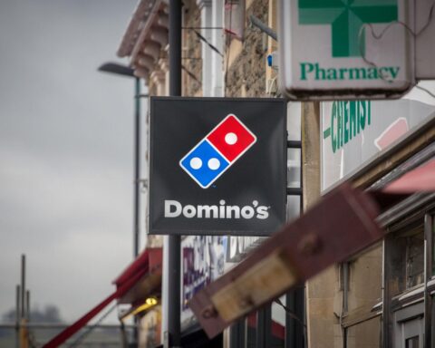pizza delivery driver supporting UK fast food sales increase demand