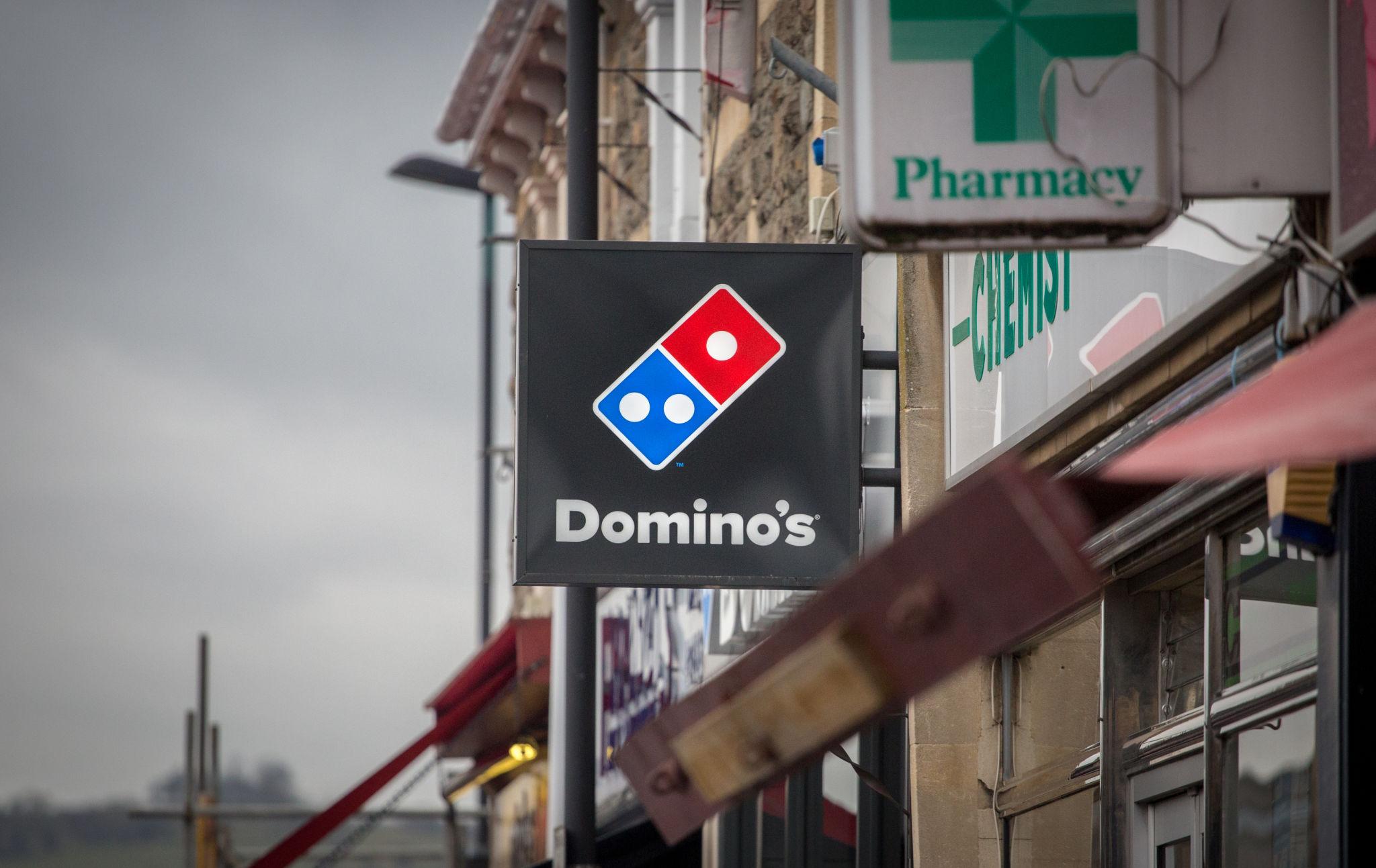 pizza delivery driver supporting UK fast food sales increase demand