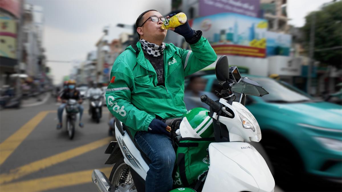 Delivery driver facing platform economy challenges due to high fuel costs in Vietnam