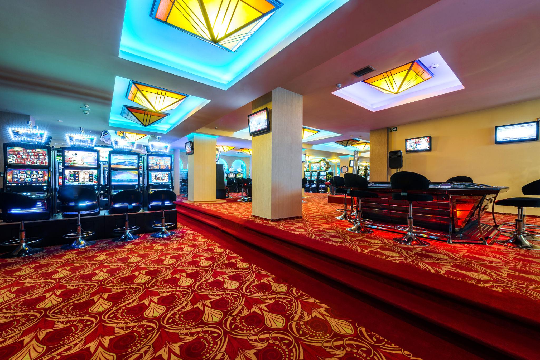 UK Betting Market News, $304M Evoke Takeover Bid Confirmed 4 UK betting market news featuring empty casino floor with gaming machines and tables