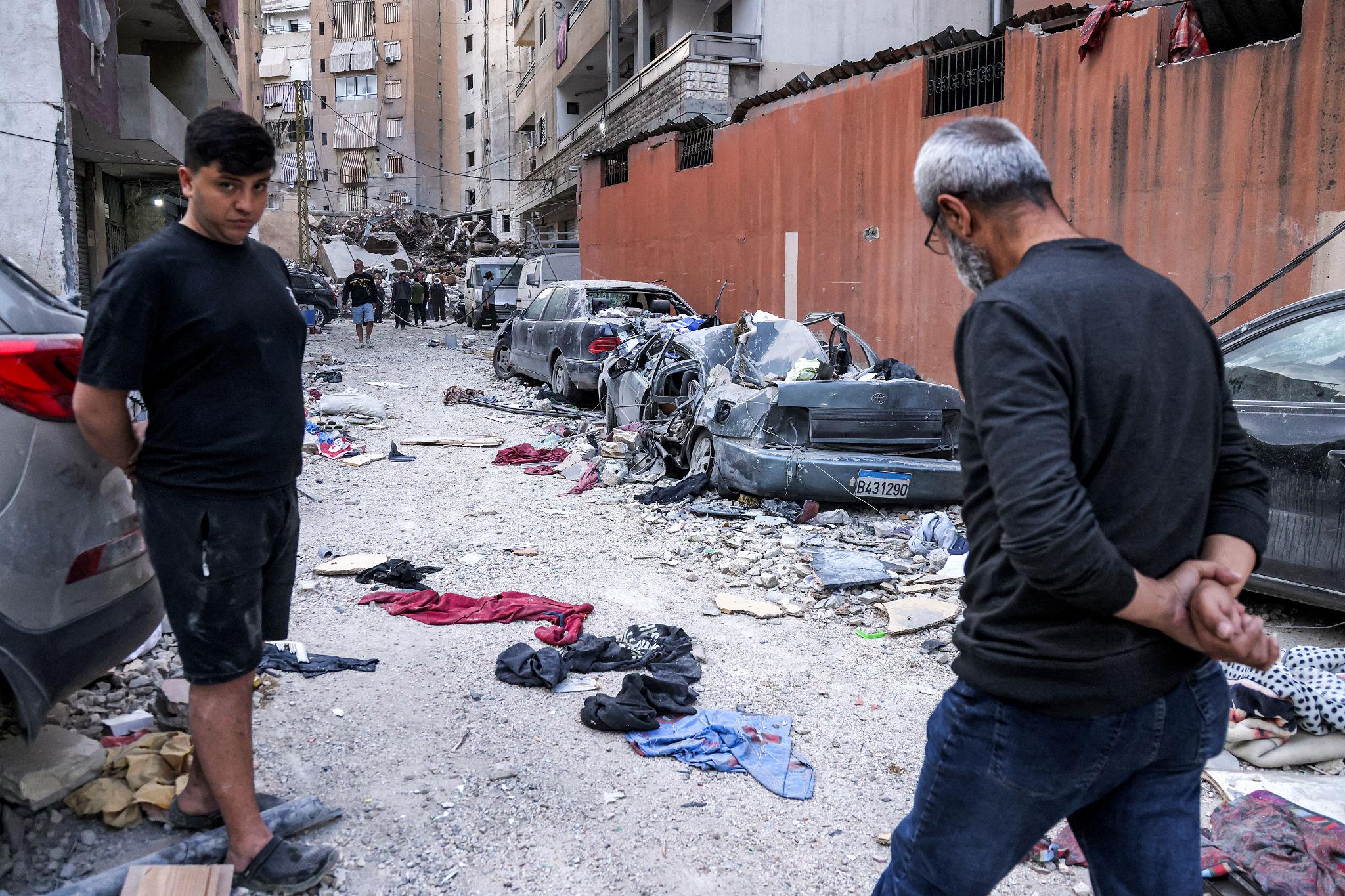 Lebanon airstrikes global reaction with smoke rising over damaged buildings