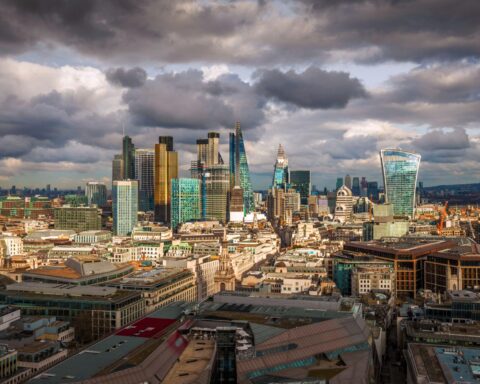 UK investment funds performance showing London financial district skyline Canary Wharf