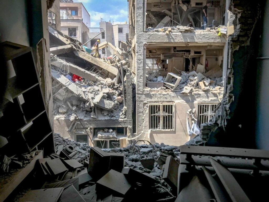 damaged roads and buildings showing Iran infrastructure damage in Tehran