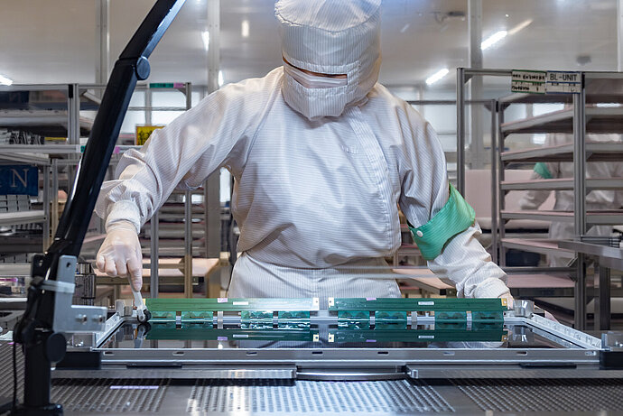 US Japan Technology Investment 2026: $13B Plan Shocks Tech Industry 2 engineers producing display panels in Japan under US Japan technology investment