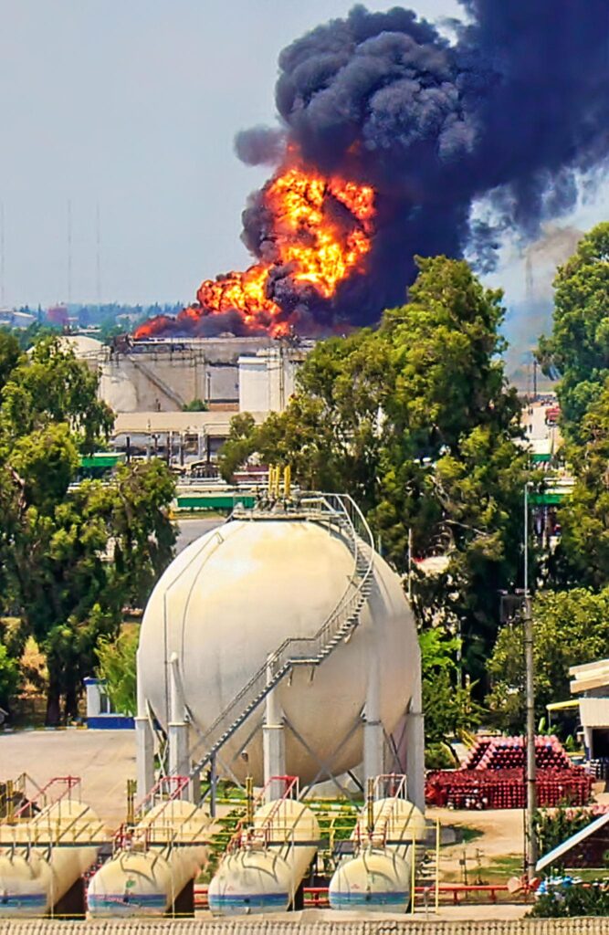 Burning oil storage tank highlighting Iran oil infrastructure damage