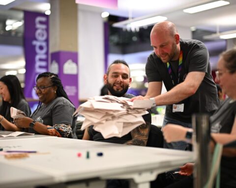 Election workers counting ballots during UK political results process