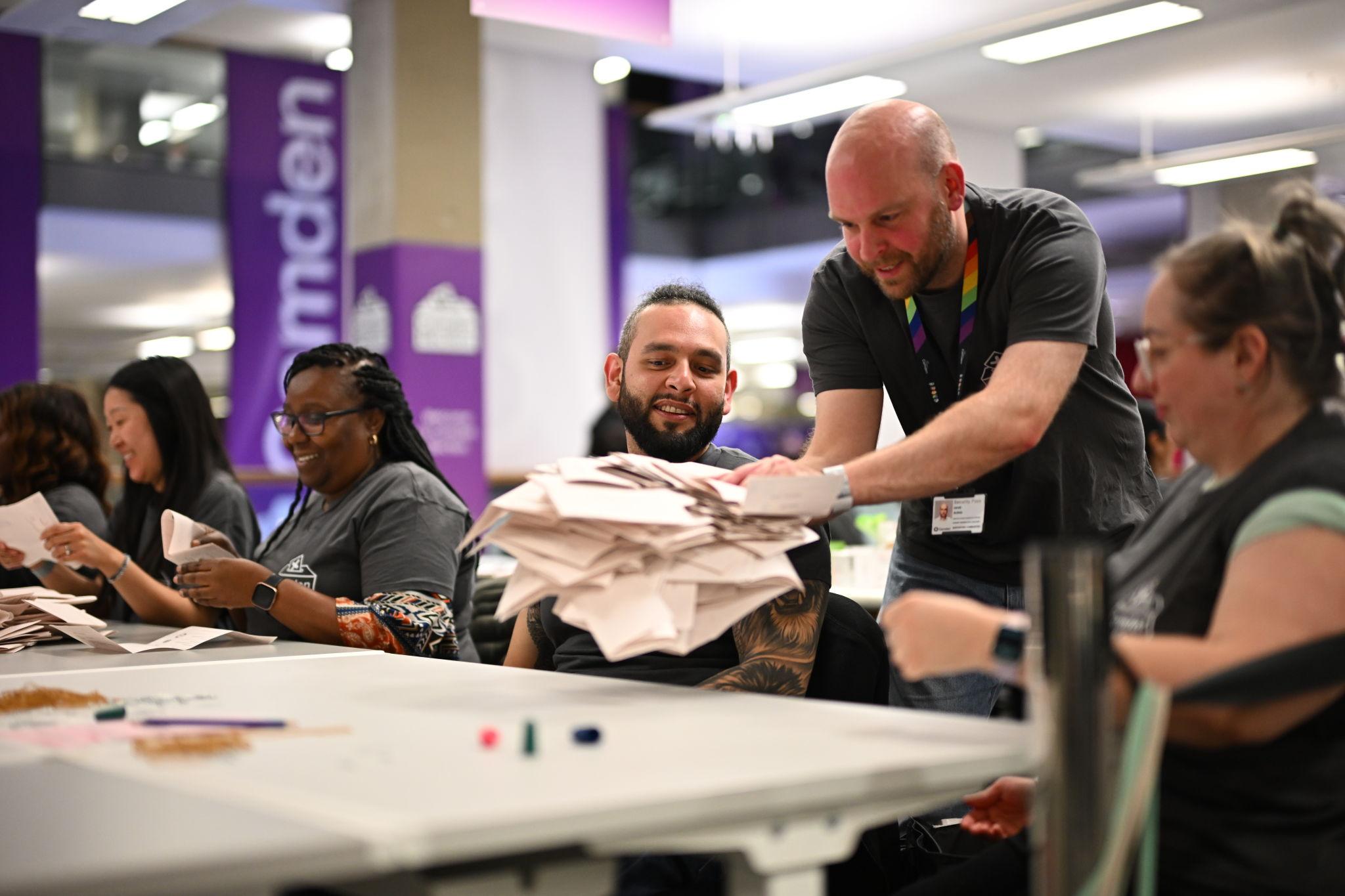 Election workers counting ballots during UK political results process