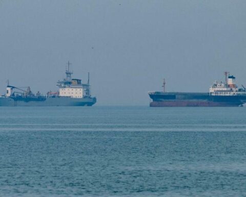 Global oil supply route risk with military escort ships accompanying oil tankers through high-risk waters