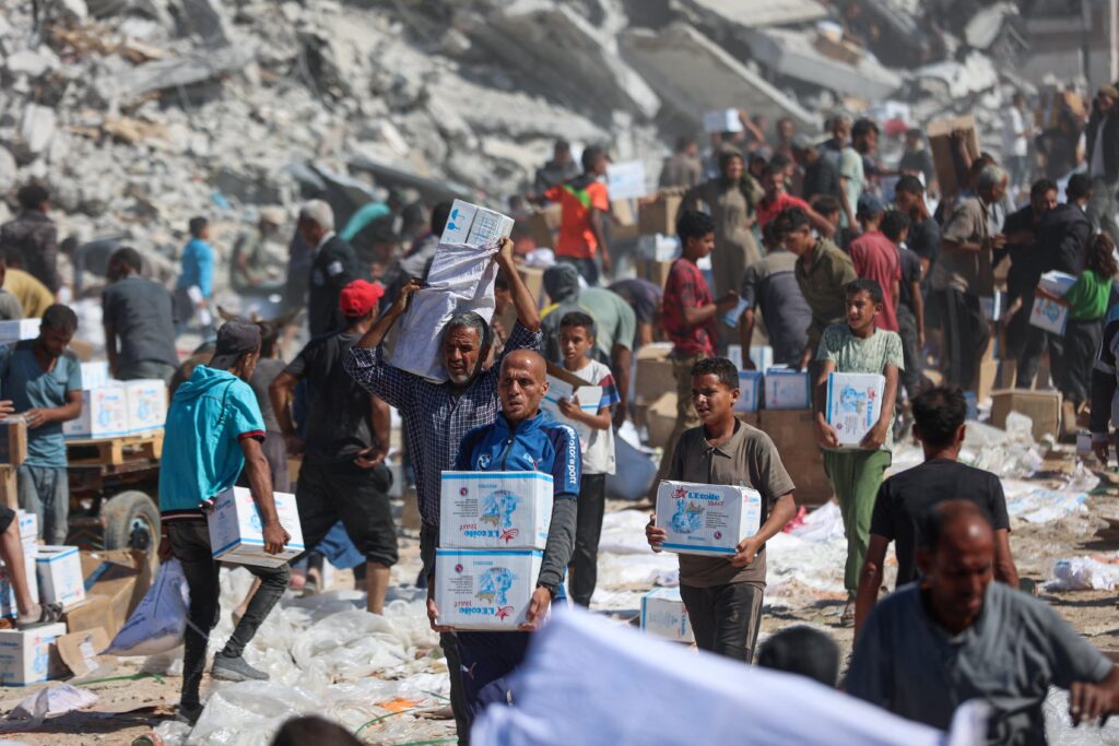 Gaza humanitarian crisis showing damaged buildings and displaced civilians in Gaza 2026