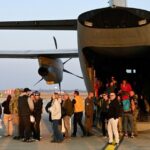 Passengers boarding US emergency flights during Middle East evacuation operation 2026