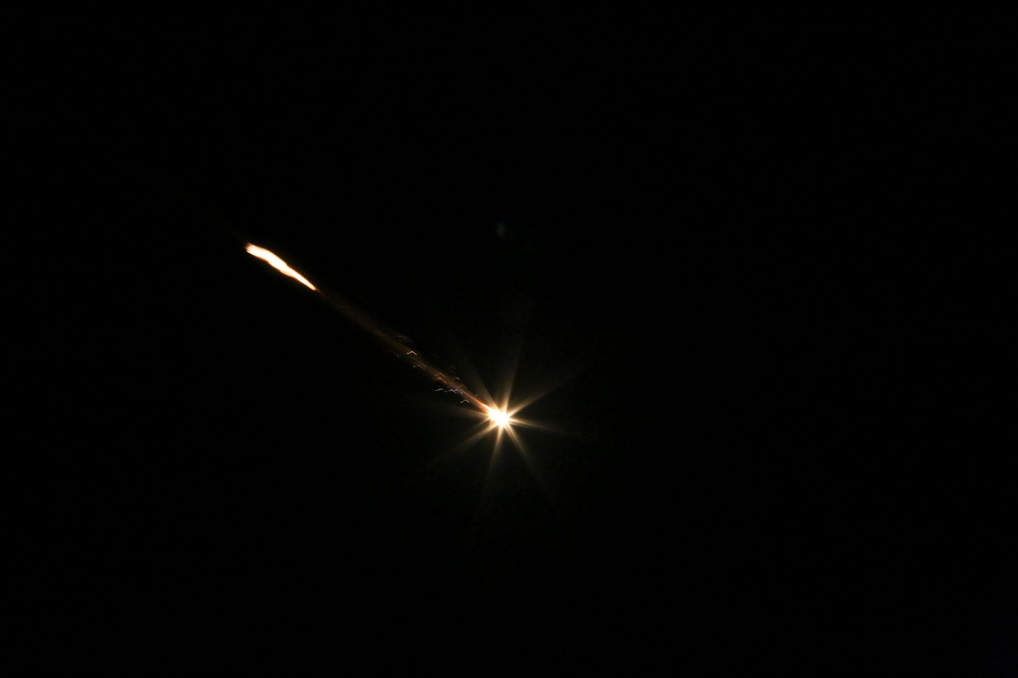 Iran missile launch lighting the night sky during military testing in Iran