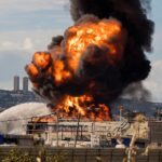 Haifa oil refinery strike aftermath with visible damage and smoke in Israel